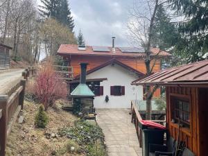 a house with a fireplace in front of it at Chalet am Sonnberg in Kleinlobming
