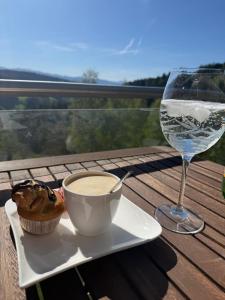 a cup of coffee and a glass of wine on a table at Chalet am Sonnberg in Kleinlobming