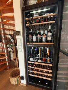 a refrigerator filled with lots of bottles of wine at Chalet am Sonnberg in Kleinlobming +15 photos