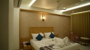 a bedroom with a bed with towels on it at Hotel Roma Kristo in Dwarka +67 photos