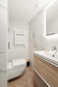 a white bathroom with a toilet and a sink at 10 Rue de la Rampe in Cannes +19 photos
