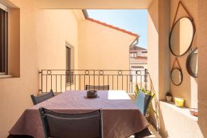 a table and chairs sitting on a balcony at 10 Rue de la Rampe in Cannes