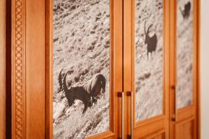a glass door with a picture of a camel on it at Bergblick - der Gasthof in Riezlern
