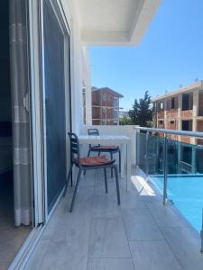 a balcony with a table and a view of a pool at Apartments Delfin in Bar