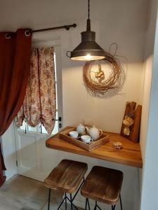 a room with a table with chairs and a light at CamElia in Garlenda +17 photos