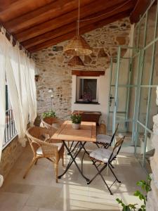 a dining room with a wooden table and chairs at CamElia in Garlenda