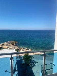 a view of the ocean from the balcony of a resort at Apartments Delfin in Bar