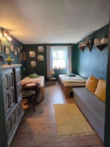 a living room with two beds and a couch at GA Grudzianka in Lwówek