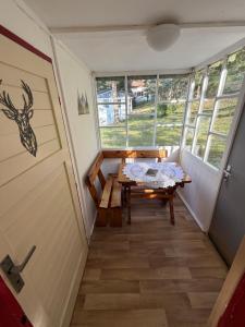 a small room with a table and a door at Chaty Kašperské Hory in Kašperské Hory +21 photos