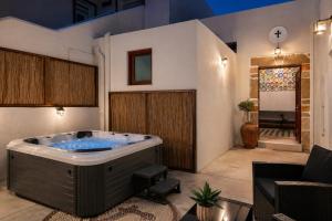 a jacuzzi tub in a living room at Antica Casa Dei Nonni with Heated Jacuzzi in Archangelos +12 photos