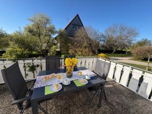 a table with food and flowers on a balcony at Ferienwohnung Sieglinde in Bad Dürrheim