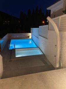a swimming pool in a backyard at night at Casa Roca Maura in L'Estartit +36 photos