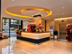 a lobby with a flower shop with a reception counter at The Sol Hotel in Phú Quốc