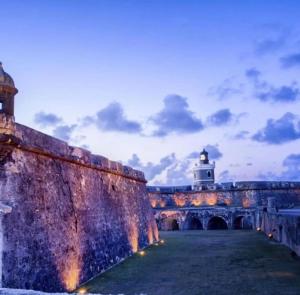 a lighthouse sitting on top of a building with a bridge at Star of the Olympus 2c Romantic Studio at Miramar Puerto Rico near beaches and Convention Center in San Juan