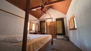 a bedroom with a bed with a wooden canopy at Happy Hippy Beach Cabanas Peanut Farm in Panama