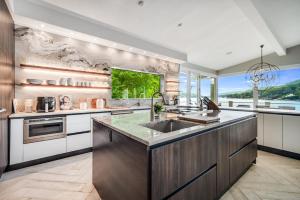 a kitchen with a sink and a large window at Waterfront Lakehouse in New Fairfield