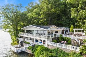 a large white house on the water at Waterfront Lakehouse in New Fairfield