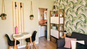 a living room with a couch and a table at We Sea in Deauville +15 photos