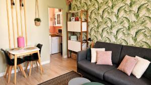 a living room with a couch and a table at We Sea in Deauville
