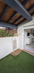 a room with a patio with green grass at Studio indépendant 2 personnes in Le Pradet