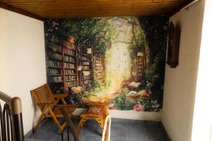 a wall mural of a library with books at SteMaMaisonette in Afantou