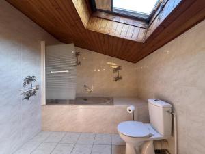 a bathroom with a toilet and a bath tub at Haramburua in Macaye +32 photos