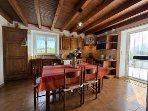 a kitchen with a table and chairs in a room at Haramburua in Macaye