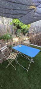 a blue table and a chair in a yard at Studio indépendant 2 personnes in Le Pradet