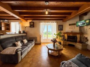 a living room with a couch and a table at Haramburua in Macaye