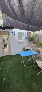 a blue ping pong table in the yard of a house at Studio indépendant 2 personnes in Le Pradet