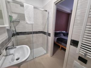 a bathroom with a sink and a glass shower at B&B Bagnara Vista Mare in Bagnara Calabra +22 photos