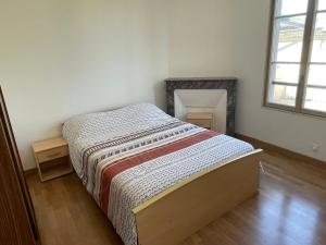a bedroom with a bed in a room with a window at Maison charmante in Le Mans +55 photos