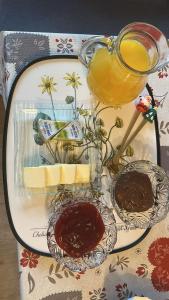 a plate with chocolate and a jug of honey and food at Stratos Apartments in Laa an der Thaya +1 photo