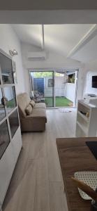 a living room with a couch and a table at Studio indépendant 2 personnes in Le Pradet