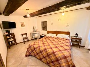 a bedroom with a bed and a tv in it at La Sibillina in Sarnano