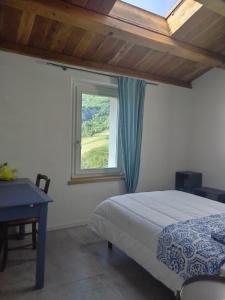 a bedroom with a bed and a window at Casina Borgo Castello in Civitella di Romagna