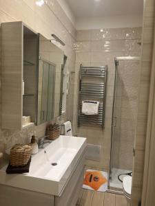 a white bathroom with a sink and a shower at DIEGOPAS Sweet Home in SantʼAntonio Abate +59 photos
