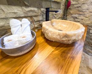 a bathroom with a large stone sink on a wooden floor at Red Frog Bungalows Ocean Resort in Short Cut +60 photos