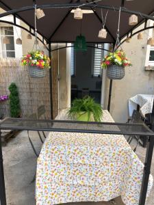 a patio table with two potted plants on it at Chez Aurore in Port-de-Bouc