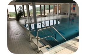 a large swimming pool in a building at Julia's Oase in Sasbachwalden