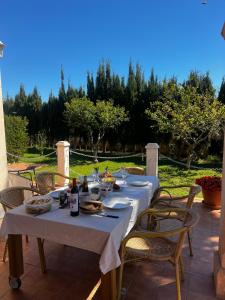 a table with food and wine on a patio at Villa en Llucmajor, Es Lluch in Llucmajor