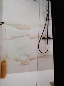 a bathroom with a shower with white marble walls at Nice flat in pretty condo in Quarteira +13 photos