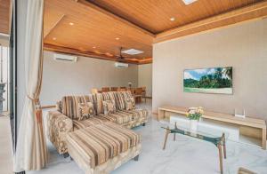 a living room with two couches and a table at Anara Pool Villa - Private House in Bophut