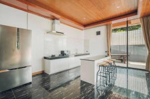 a kitchen with white cabinets and a counter at Anara Pool Villa - Private House in Bophut