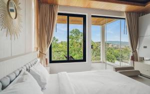 a bedroom with a large bed and large windows at Anara Pool Villa - Private House in Bophut +29 photos