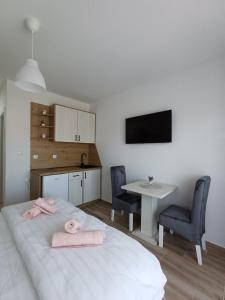 a bedroom with a bed and a table with two chairs at RIO Residence in Soko Banja