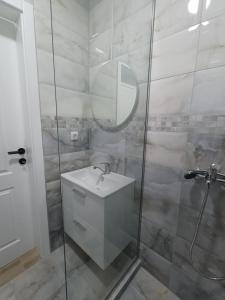 a bathroom with a sink and a shower with a mirror at RIO Residence in Soko Banja +68 photos