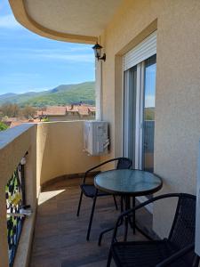 a balcony with a table and chairs and a view at RIO Residence in Soko Banja