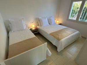 a bedroom with two beds and a window at Villa La Gavina Sea View Pool and Beaches in Blanes +21 photos