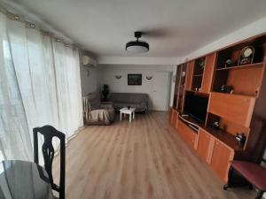 a living room with a couch and a television at Alojamiento El Sevillano in Cullera +9 photos